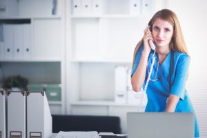 Female doctor talking on phone in diagnostic center . Female doctor talking on phone in diagnostic center .