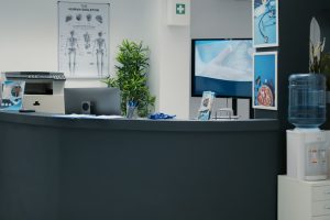 Nobody in empty waiting room lobby with desktop at reception Nobody in empty waiting room lobby with desktop at reception